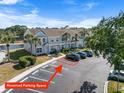 Community aerial view showcasing a reserved parking spot, landscaping, and nearby pond at 5084 Misty Canal Pl, Bradenton, FL 34203