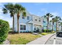 A row of beautiful townhomes showcases well-manicured lawns and mature palm trees at 5084 Misty Canal Pl, Bradenton, FL 34203