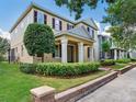 Two-story home with a manicured lawn, complemented by trees and a brick-lined walkway at 5409 Fishhawk Ridge Dr, Lithia, FL 33547