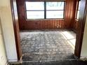 Wood-paneled living room featuring a large window for natural light at 5700 65Th N Ave, Pinellas Park, FL 33781