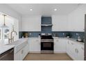 Bright kitchen featuring white cabinetry, stainless steel oven, and complementary hardware at 6321 Balboa Ln, Apollo Beach, FL 33572