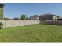 Large, fenced backyard with well-maintained lawn at 6707 Blue Moon Way, Sun City Center, FL 33573