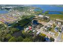 An aerial view reveals the property's waterfront location, bordered by lush greenery and tranquil waters at 6908 11Th E Ave, Palmetto, FL 34221