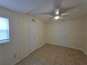 Clean bedroom with tile flooring, a ceiling fan, and a closet for storage at 718 Paris S Ave, St Petersburg, FL 33701
