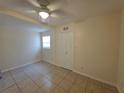 Bright bedroom featuring tile floors, a ceiling fan, and neutral wall paint at 718 Paris S Ave, St Petersburg, FL 33701