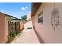 A view of the exterior side of the home with a fence and a potted plant at 7203 55Th N Ave, St Petersburg, FL 33709