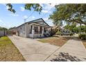 A charming single-story home with a well-maintained lawn and a concrete driveway at 7509 S West Shore Blvd, Tampa, FL 33616