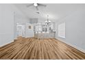 Open living space boasts wood flooring, modern lighting, and a stone-accented breakfast bar at 7509 S West Shore Blvd, Tampa, FL 33616