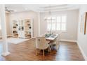 Elegant dining room with modern chandelier, hardwood floors, and natural light at 8338 Old Town Dr, Tampa, FL 33647