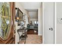 Inviting entryway with decorative mirror, console table, and tiled floor at 8728 Mcadam Pl, Tampa, FL 33634