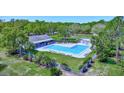 Aerial view of the Westlake Village community pool with a clubhouse and surrounding greenery at 915 Rolling Hills Dr, Palm Harbor, FL 34683