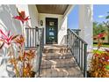 Inviting front porch with brick steps and a modern black front door featuring glass panels at 101 Biscayne Ave, Tampa, FL 33606