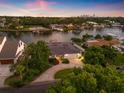 Breathtaking aerial view of a waterfront home with lush landscaping and stunning sunset sky at 1124 35Th Ne Ave, St Petersburg, FL 33704