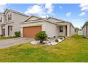 Single-story home with a well-manicured lawn and a brick-paved driveway at 11819 Brighton Knoll Loop, Riverview, FL 33579