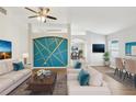 Bright living room with modern decor, sleek furniture, and a unique accent wall design at 1333 Dragon Head Dr, Valrico, FL 33594