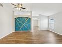 Spacious living room with an accent wall, hardwood floors, neutral paint, and plenty of natural light at 1333 Dragon Head Dr, Valrico, FL 33594