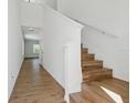 Bright foyer featuring hardwood floors and a staircase leading upstairs at 13981 Lilac Sky Ter, Bradenton, FL 34211