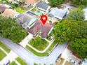 A home in a serene neighborhood is pinpointed by a red marker amidst lush trees at 1424 Ridge Shore Dr, Tarpon Springs, FL 34689