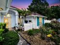 Charming entryway featuring lush landscaping and stone groundcover, leading to an inviting doorway at 1424 Ridge Shore Dr, Tarpon Springs, FL 34689
