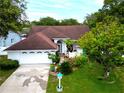 An aerial shot of a charming single-story home with a well-manicured lawn and a two-car garage at 1424 Ridge Shore Dr, Tarpon Springs, FL 34689