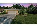 Charming single Gathering home featuring mature landscaping, well manicured lawn, and a two car garage at 15014 Winterwind Dr, Tampa, FL 33624