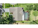Aerial view of a home with a screen enclosed pool and a well maintained backyard at 16214 W Course Dr, Tampa, FL 33624