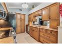 Well-lit kitchen with stone countertops and light wood cabinets at 16214 W Course Dr, Tampa, FL 33624
