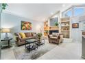 Cozy living room with a fireplace and built-in shelving at 16214 W Course Dr, Tampa, FL 33624