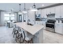 Modern kitchen featuring a large island, stainless steel appliances, and sleek white cabinetry at 16305 Pebble Ridge Dr, Lakewood Ranch, FL 34211