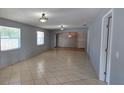 Open floor plan with neutral walls, tiled flooring and natural light make this a desirable living space at 1708 E Genesee St, Tampa, FL 33610