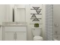 Well-lit bathroom featuring stylish vanity, modern fixtures, and decorative wall art at 17506 Nectar Flume Dr, Land O Lakes, FL 34638