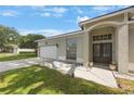 View of the front entrance, featuring a garage and landscaped yard with a nice walkway at 18520 Ambly Ln, Tampa, FL 33647
