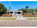 Beautiful exterior view showcasing the lovely yard and unique fencing at 212 41St S St, St Petersburg, FL 33711