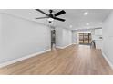 Bright, open-concept living space with modern ceiling fan and stylish wood flooring at 2214 Selkirk St, Valrico, FL 33594