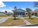 Charming single Gathering home featuring a screened-in front porch and a well-maintained lawn at 2217 Stuart St, Tampa, FL 33605