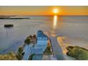 An aerial view of a waterfront property at sunset, offering stunning ocean views at 2417 Sunset Vista Dr, Spring Hill, FL 34607