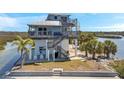 Coastal home featuring outdoor stairs, balconies and stunning views of the water at 2417 Sunset Vista Dr, Spring Hill, FL 34607