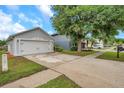 Residential property with a spacious driveway and well-manicured lawn at 2907 Mingo Dr, Land O Lakes, FL 34639
