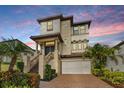 Elegant two-story home featuring landscaped yard, brick driveway, and covered entryway at 3585 Torino Ln, Palm Harbor, FL 34683
