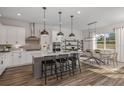 Modern kitchen with a large island, stainless steel appliances, and an adjacent dining area at 37202 Clinch Cir, Zephyrhills, FL 33540