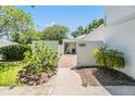 Inviting entrance to home with brick walkway, lush landscaping, and clear signage for 4002 at 4002 Cypress Ct # 4002, Tampa, FL 33618