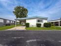 Charming single-story home with a covered carport and blue shutters at 5150 Damsen Cir, New Port Richey, FL 34653