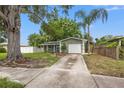 Beautiful home boasting a well-manicured lawn, mature trees, and a driveway at 5245 3Rd N Ave, St Petersburg, FL 33710