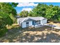 Aerial view of a well-maintained single-story home with a lawn and mature trees at 6017 6Th Ave, New Port Richey, FL 34653