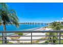 Scenic balcony view showcasing a bridge over calm blue waters with sandy beach at 6081 Bahia Del Mar Cir # 452, St Petersburg, FL 33715