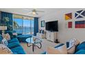 Cozy living room with blue furnishings, nautical decor, and serene waterfront views at 6081 Bahia Del Mar Cir # 452, St Petersburg, FL 33715