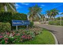 The Bahia Pointe entrance is marked by lush landscaping, including colorful flowers and mature palm trees at 6287 Bahia Del Mar Cir # 404, St Petersburg, FL 33715