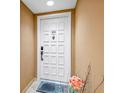 Condo entrance featuring unit number 404, a Welcome mat, and neutral wall color at 6287 Bahia Del Mar Cir # 404, St Petersburg, FL 33715