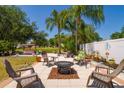 Outdoor patio featuring comfortable seating and a central fire pit, perfect for relaxation and entertaining guests outdoors at 7132 Colony Pointe Dr, Riverview, FL 33578