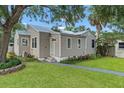 Attractive home with neutral siding, black-trimmed windows, and a walkway to the front door at 921 W Coral St, Tampa, FL 33602